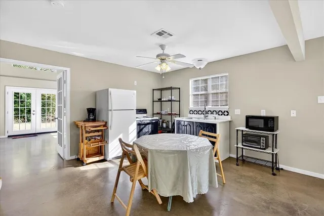 a view of a dining room with furniture and a window