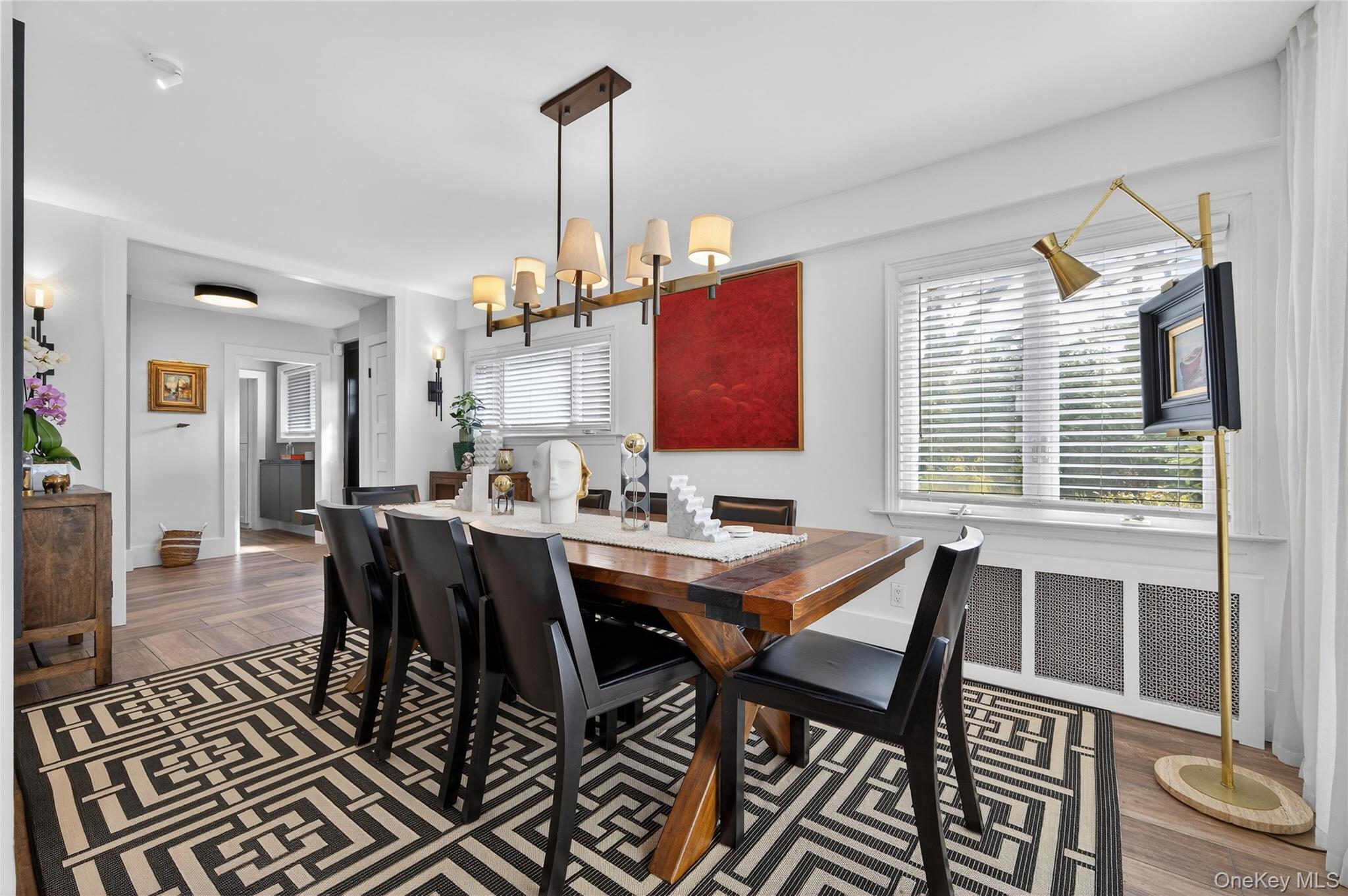 3 Beacon Hill Road Port Washington, NY 11050 - Photo 12 of 43 a view of a dining room and livingroom with furniture wooden floor a chandelier