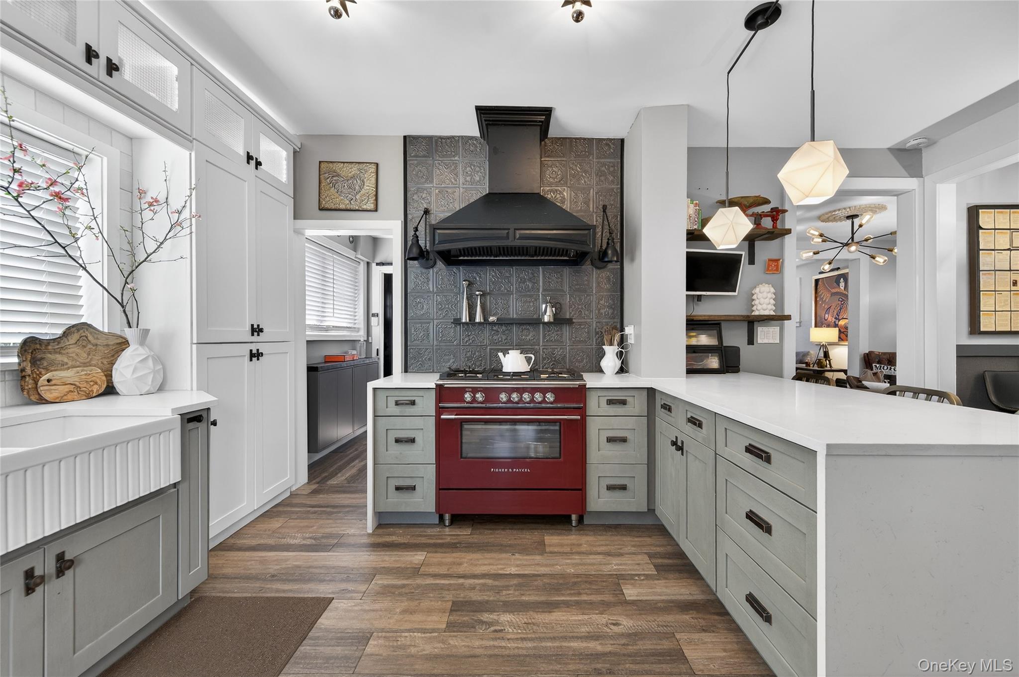 3 Beacon Hill Road Port Washington, NY 11050 - Photo 13 of 43 a kitchen with stainless steel appliances a stove and a chandelier