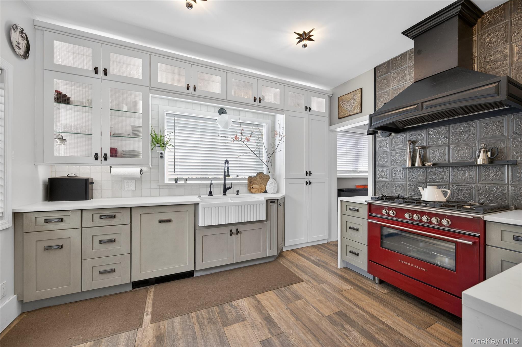 3 Beacon Hill Road Port Washington, NY 11050 - Photo 14 of 43 a kitchen with cabinets oven and a dishwasher with wooden floor