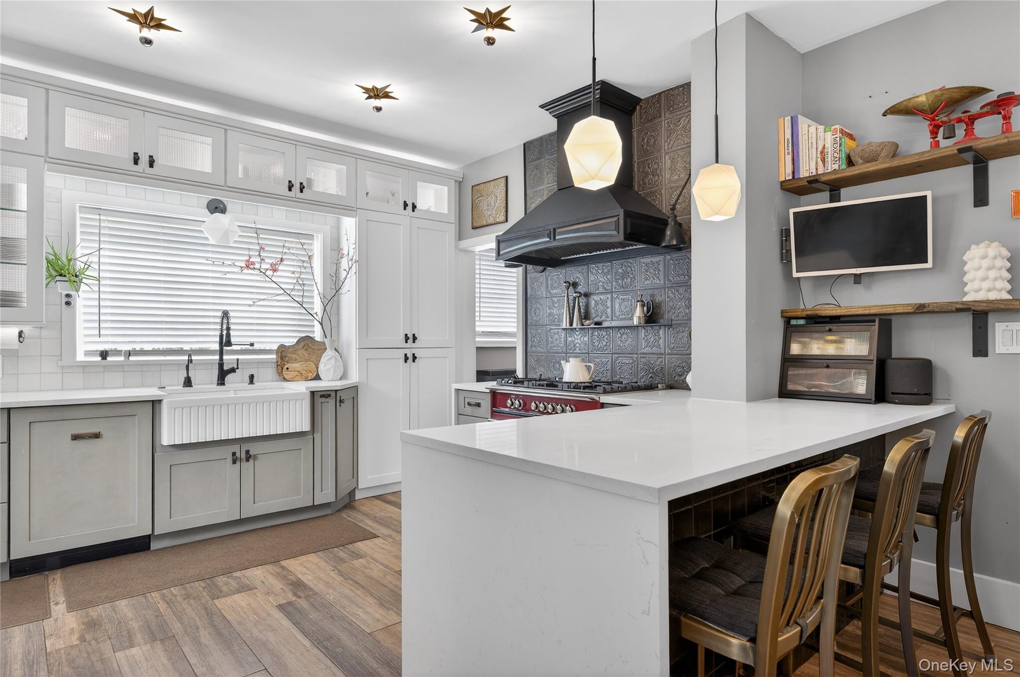 3 Beacon Hill Road Port Washington, NY 11050 - Photo 16 of 43 a kitchen with cabinets a sink and chairs in it