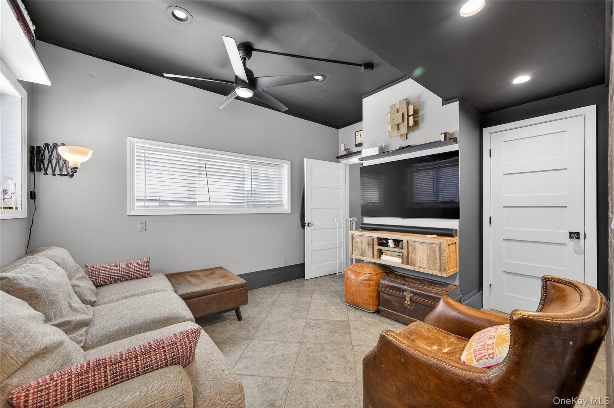 3 Beacon Hill Road Port Washington, NY 11050 - Photo 17 of 43 a living room with furniture and a flat screen tv