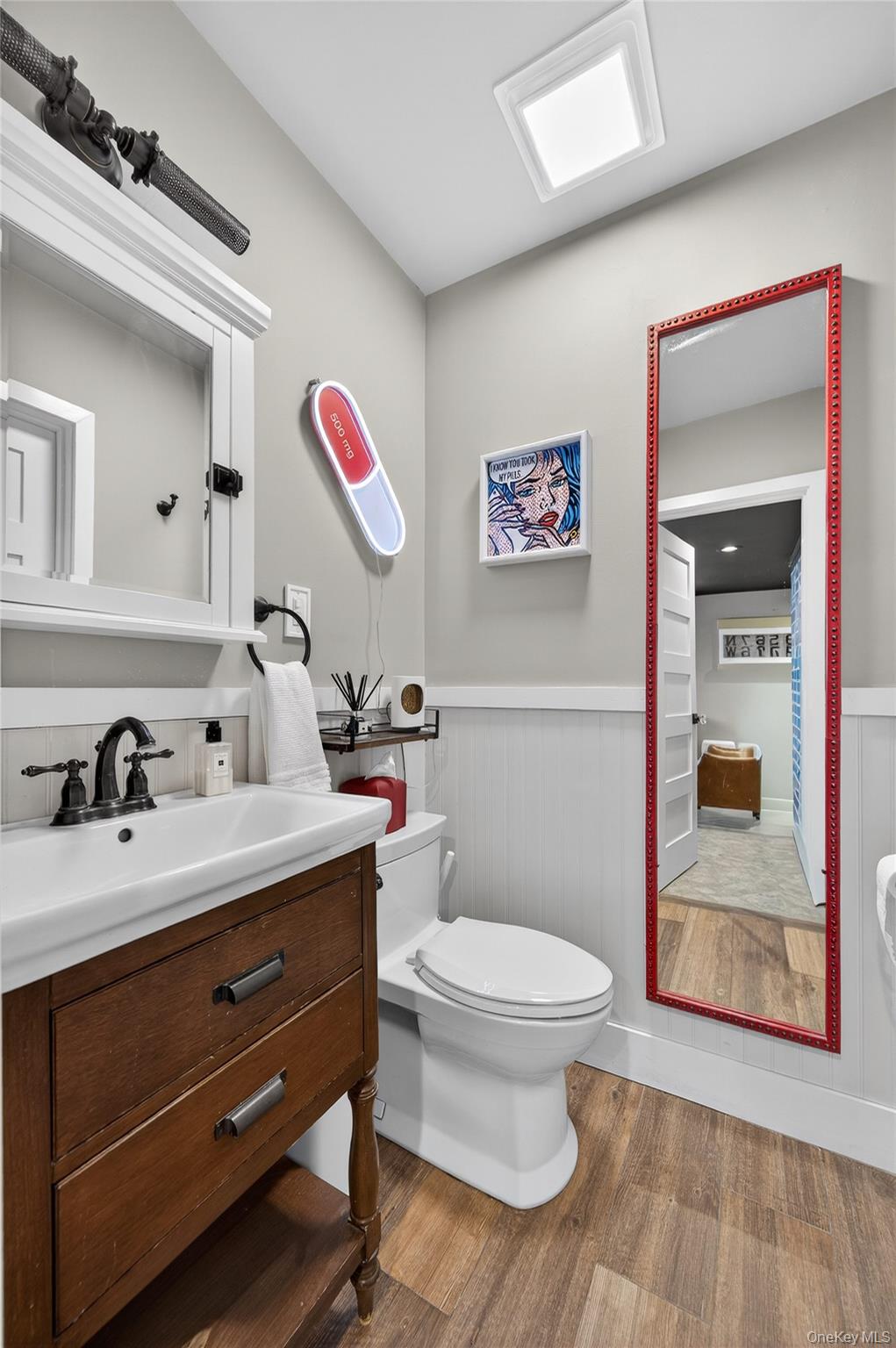 3 Beacon Hill Road Port Washington, NY 11050 - Photo 18 of 43 a bathroom with a toilet a sink and mirror