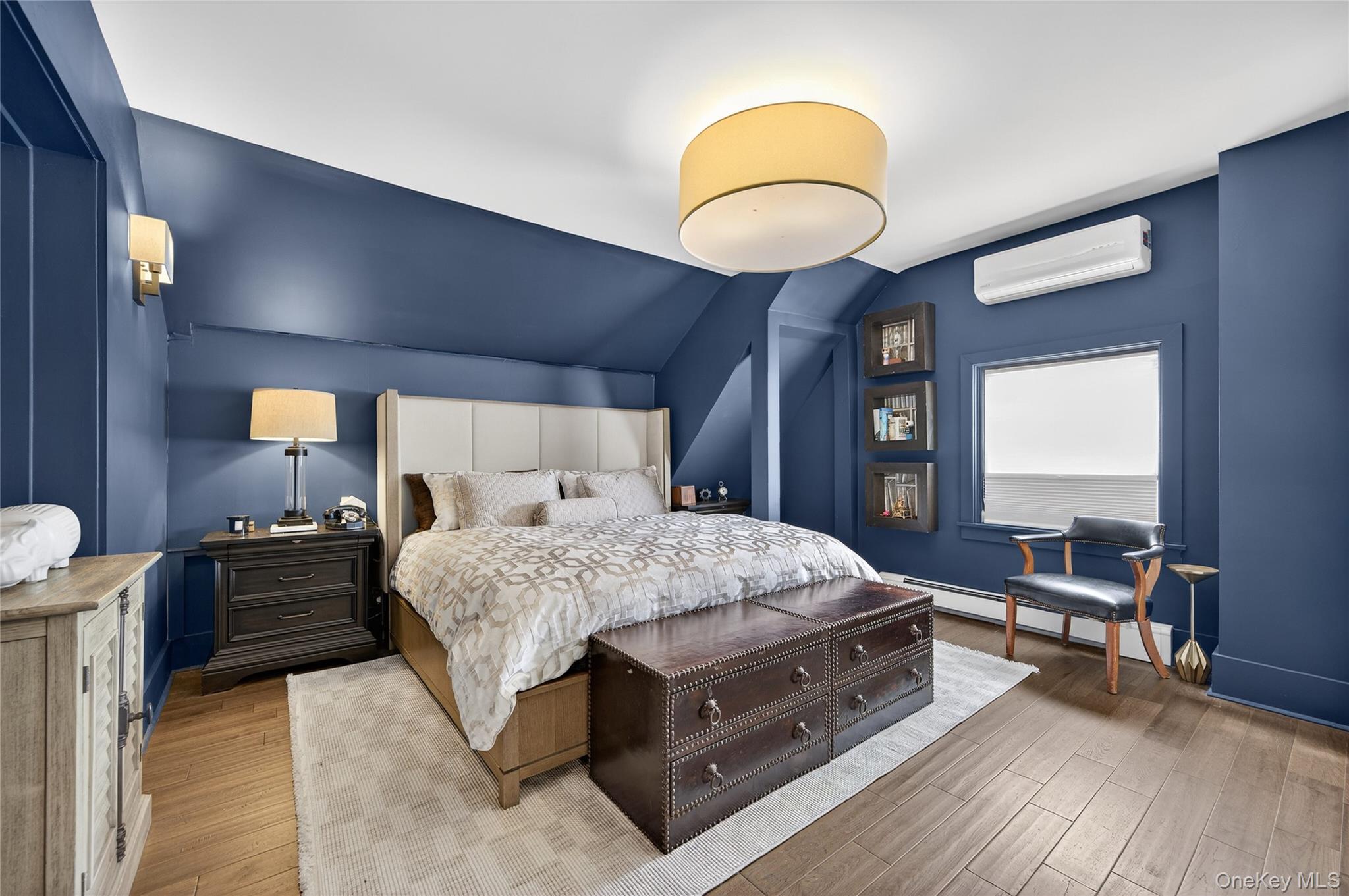 3 Beacon Hill Road Port Washington, NY 11050 - Photo 20 of 43 a bedroom with a bed and wooden floor