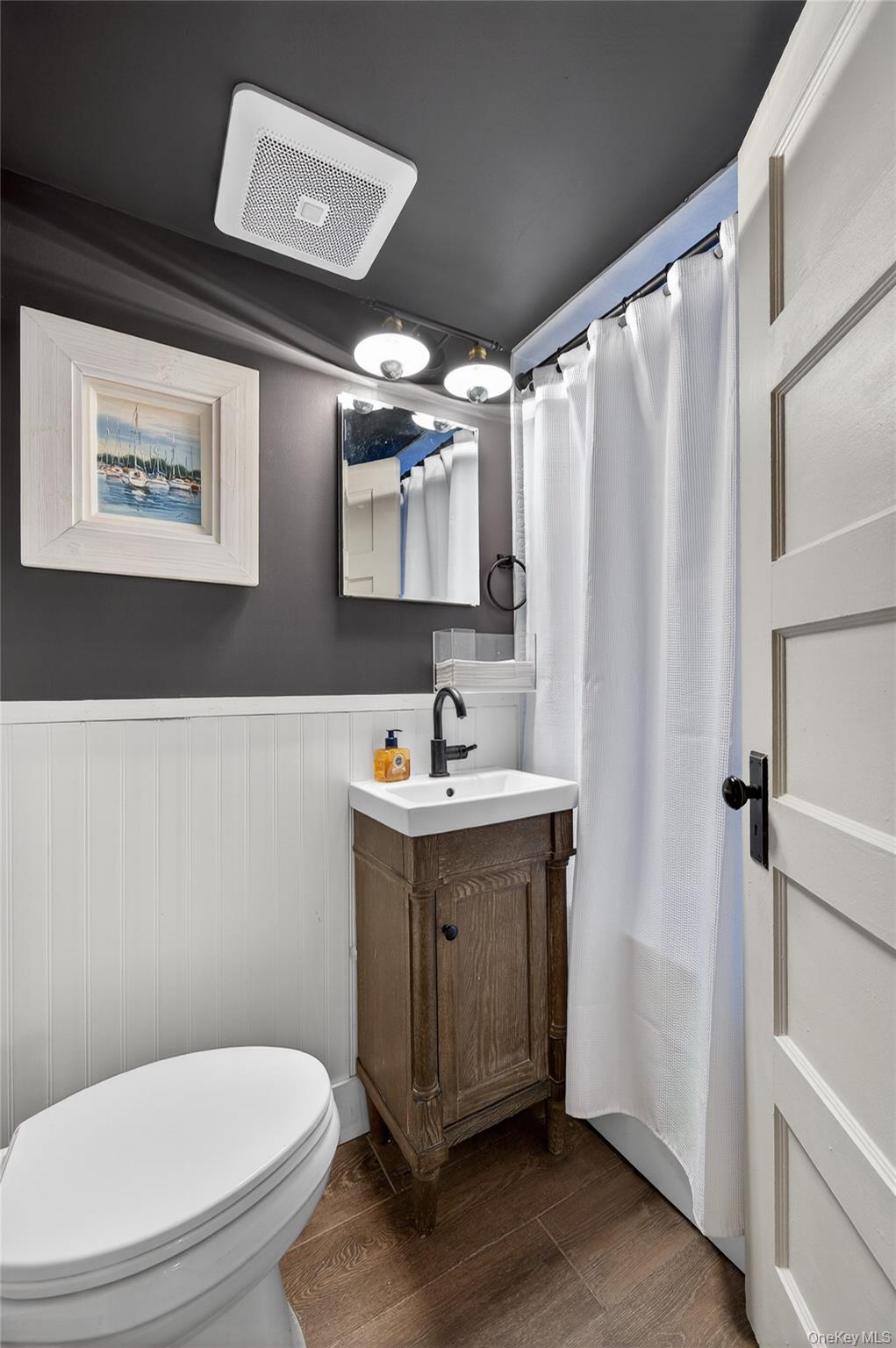 3 Beacon Hill Road Port Washington, NY 11050 - Photo 30 of 43 a bathroom with a sink mirror vanity and toilet