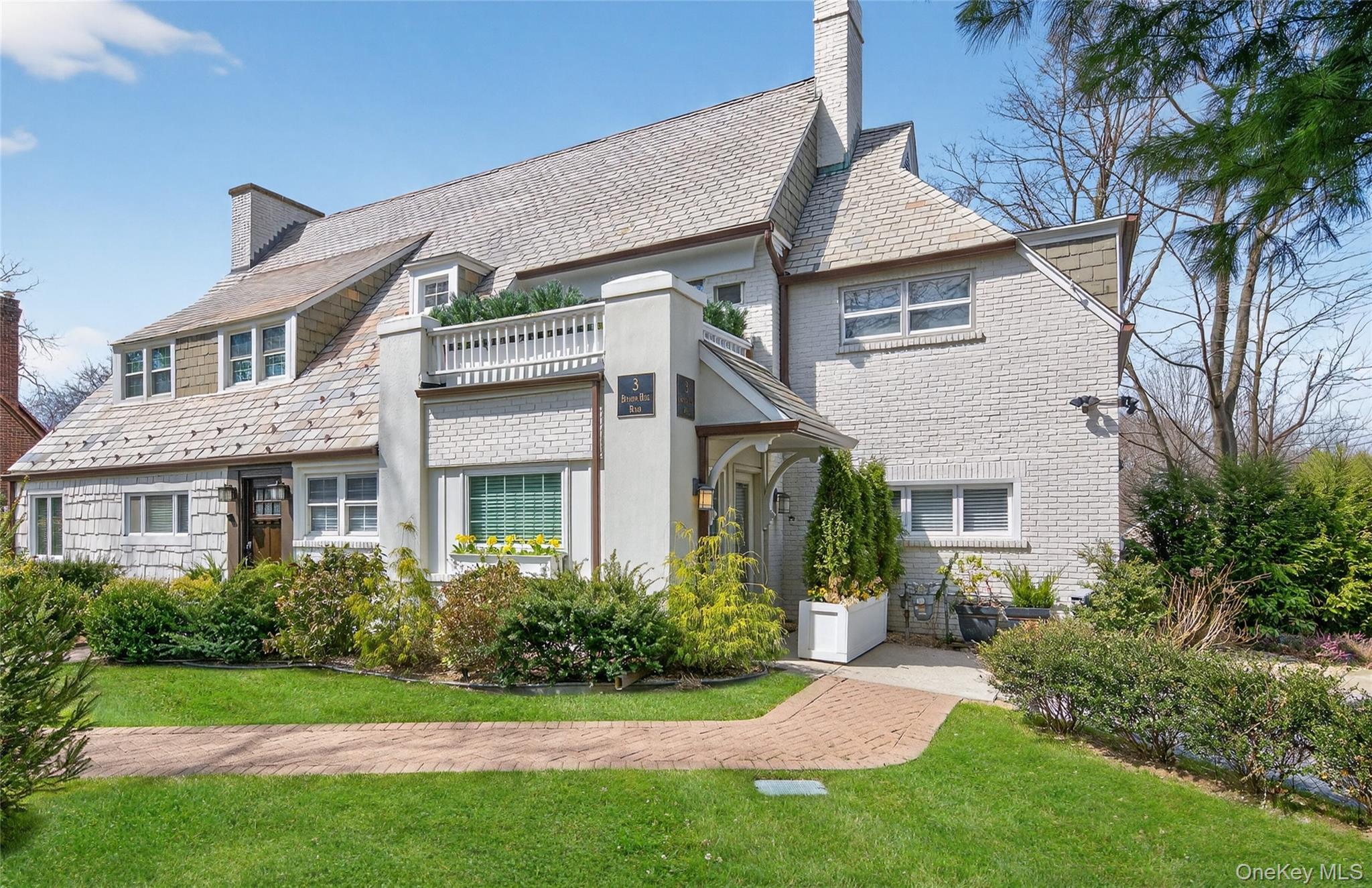 3 Beacon Hill Road Port Washington, NY 11050 - Photo 3 of 43 a front view of a house with a yard