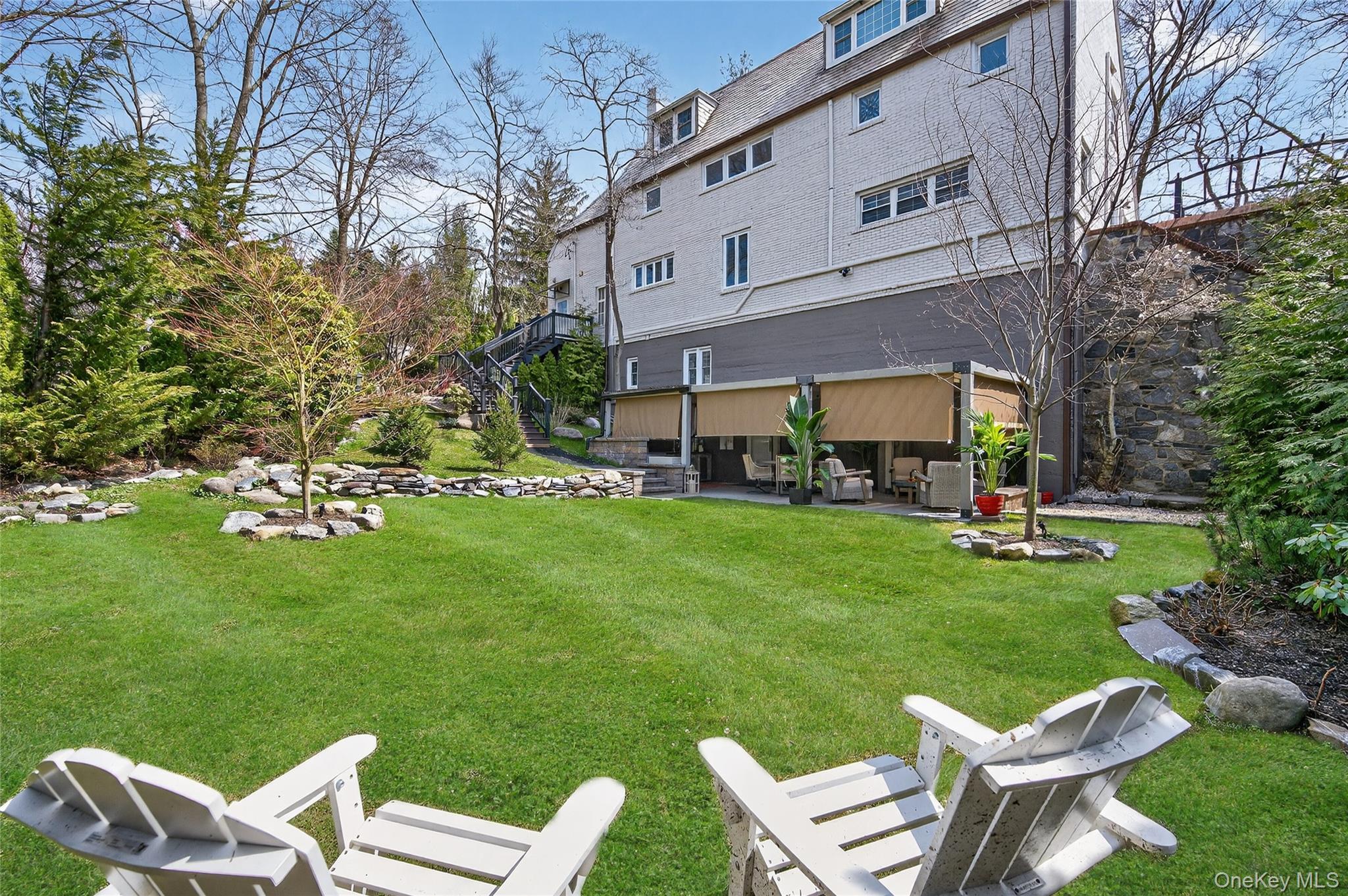 3 Beacon Hill Road Port Washington, NY 11050 - Photo 34 of 43 a view of a big chair and table in backyard