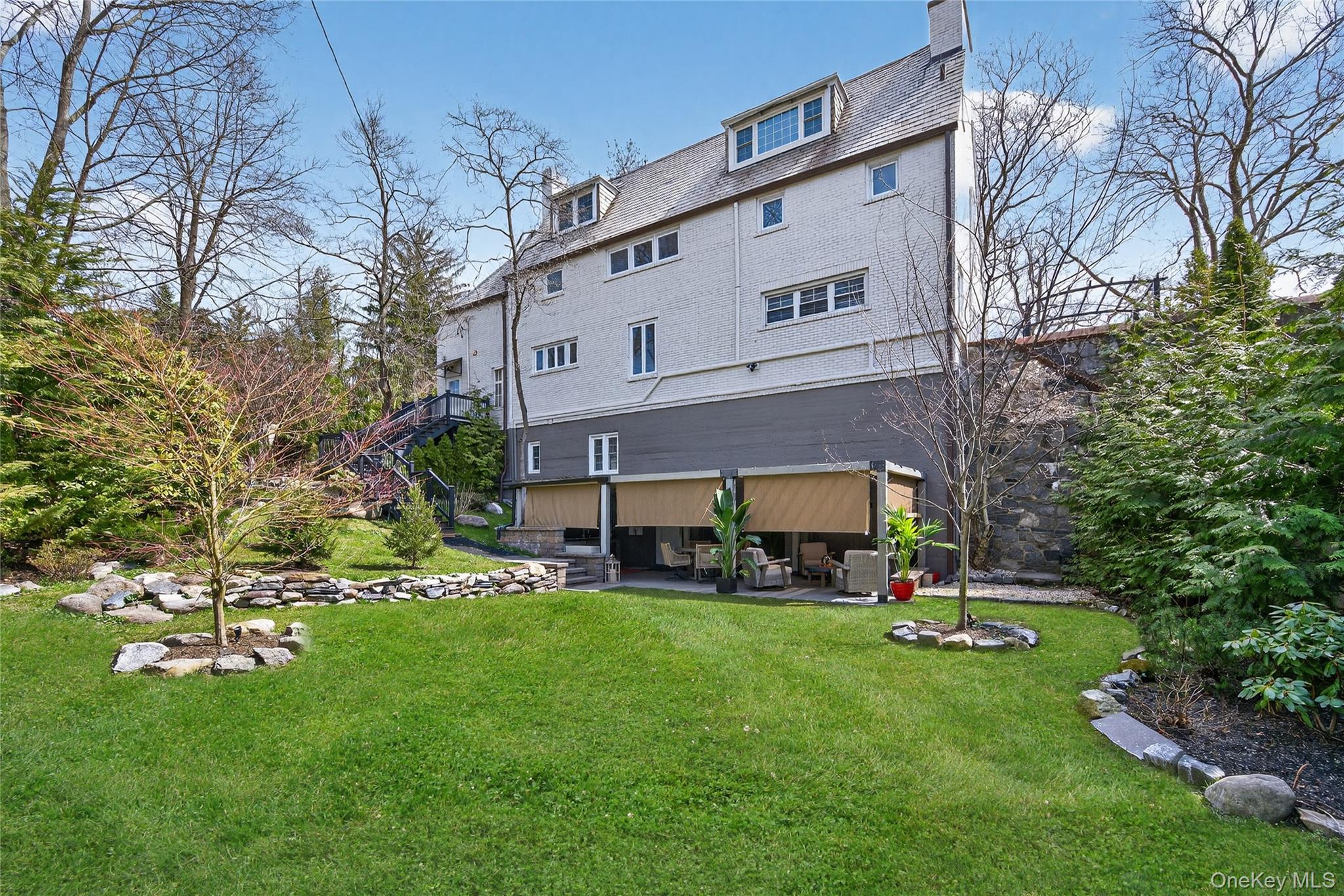 3 Beacon Hill Road Port Washington, NY 11050 - Photo 35 of 43 a view of a house with a yard porch and sitting area