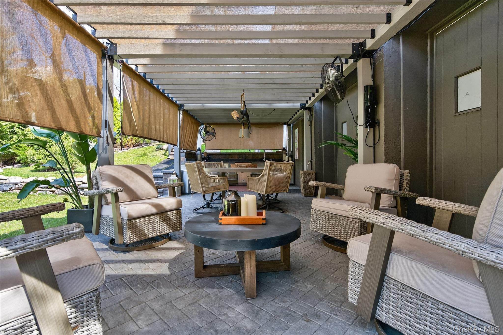 3 Beacon Hill Road Port Washington, NY 11050 - Photo 36 of 43 a outdoor living space with furniture and a fireplace