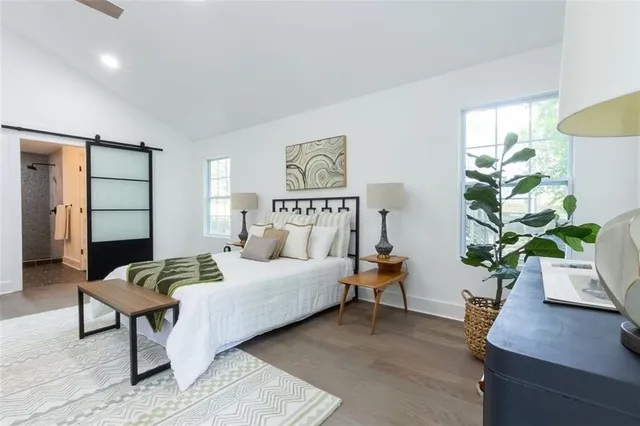 a bedroom with a bed table and couch