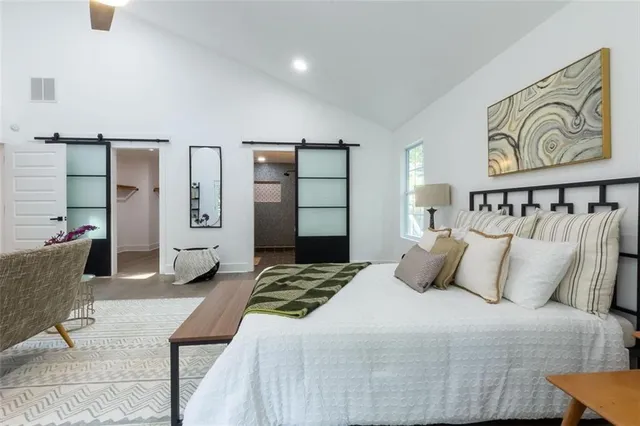 a bedroom with a bed and a couch