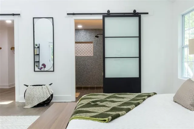 a bedroom with a bed and a window