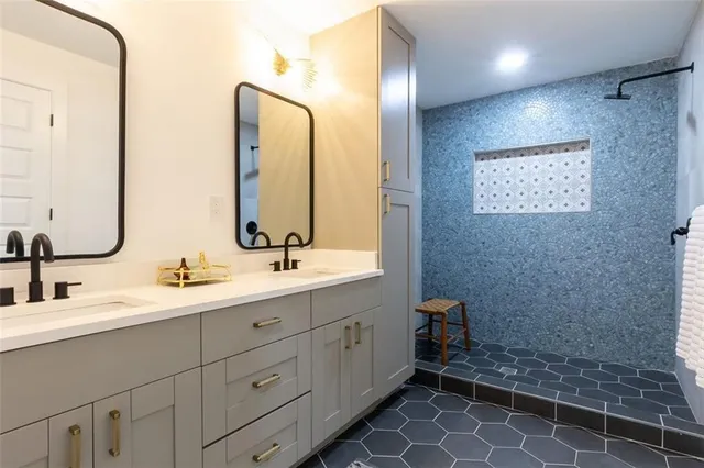 a bathroom with a double vanity sink mirror and toilet