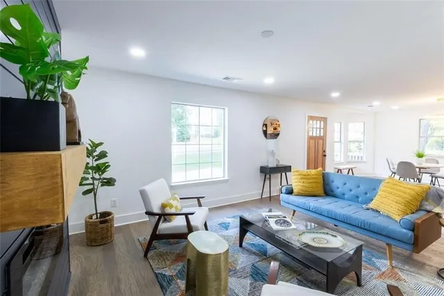 a living room with furniture and a potted plant