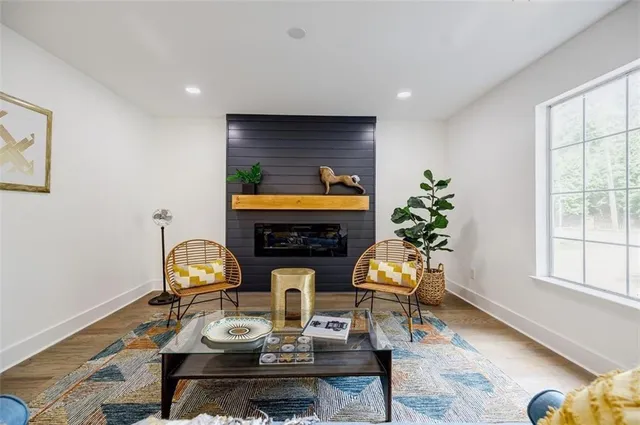 a living room with furniture a fireplace and potted plants