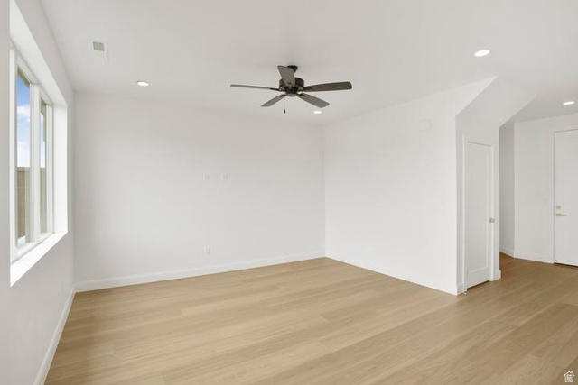 990 Manen Street Washington, UT 84780 - Photo 10 of 43 Spacious interior room featuring light wood-finish flooring, crisp white walls, and a multi-pane window