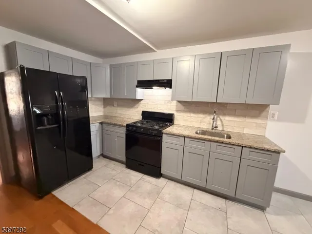 a kitchen with a sink stove and refrigerator