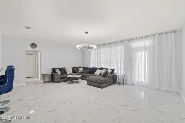 a living room with furniture and a large window