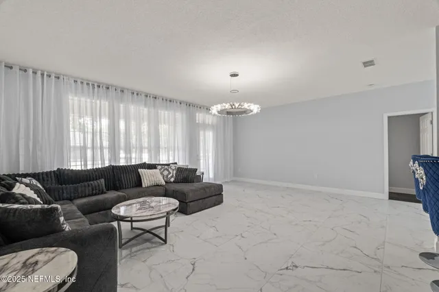 a kitchen with granite countertop a white refrigerator oven a sink and white cabinets