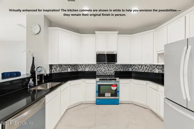 a kitchen with stainless steel appliances granite countertop a refrigerator a stove a sink a dining table and chairs with wooden floor