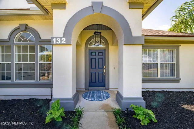 a front view of a house with garden