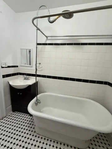 a bathroom with a bathtub and a shower