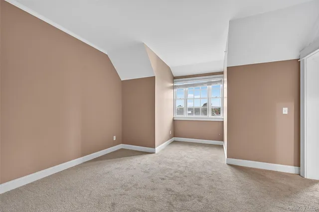 a view of an empty room with a kitchen