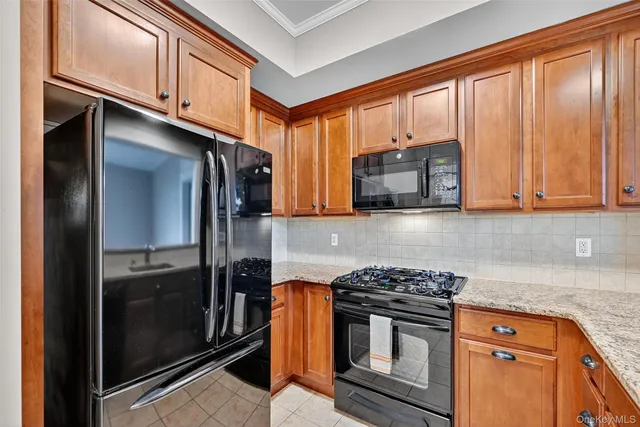 a kitchen with stainless steel appliances granite countertop a stove microwave and refrigerator