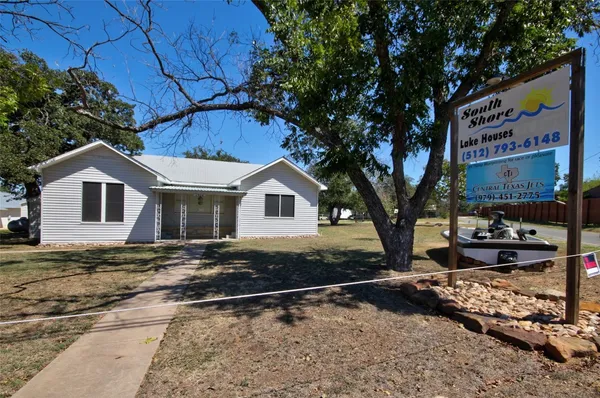 a view of a park with bench and trees