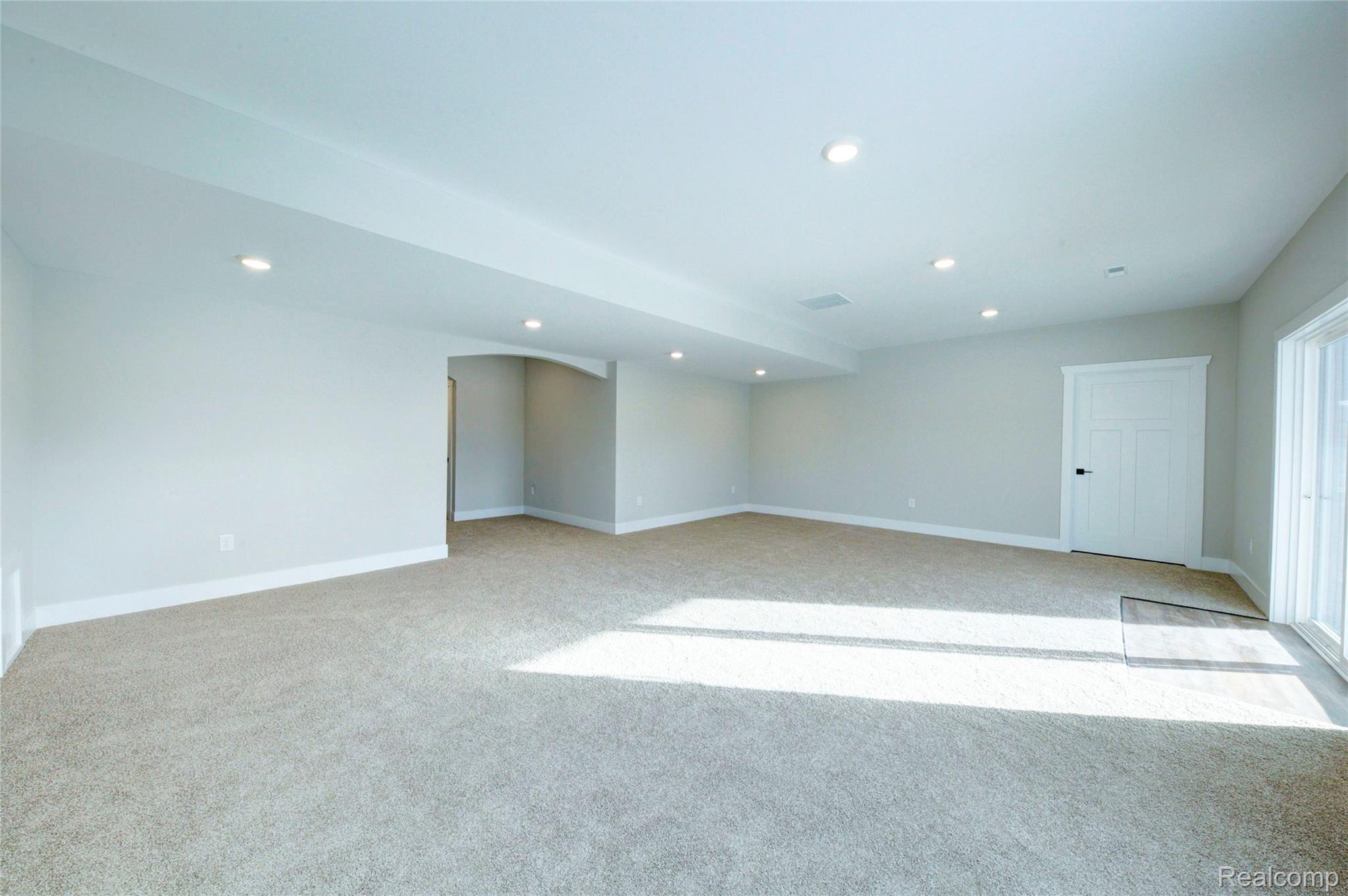 579 Round Rock (moh80) Howell, MI 48843 - Photo 31 of 42 Empty room with light colored carpet and recessed lighting