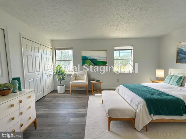 a spacious bedroom with a bed and a dresser