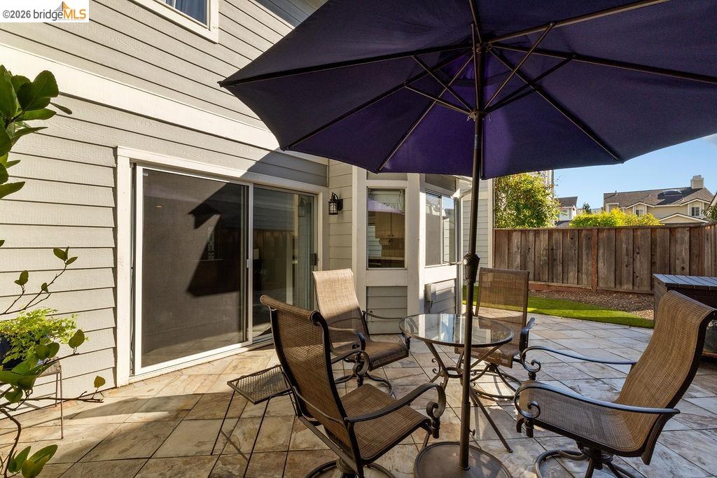 724 Winterside Circle San Ramon, CA 94583 - Photo 30 of 43 Paver patio with a sliding glass door entry to the interior, featuring a wood fence, and a manicured lawn area