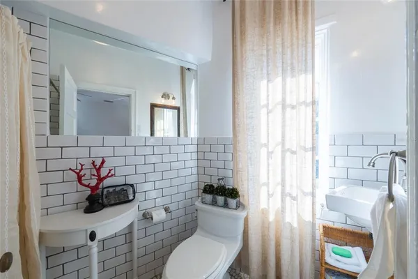 a living room with furniture a rug and a chandelier