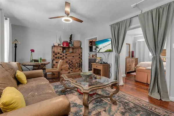 a living room with furniture a rug and a window