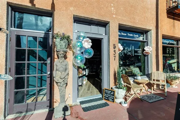 a view of a street with potted plants