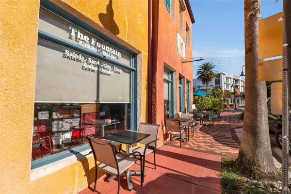 a view of a patio with table and chairs potted plants