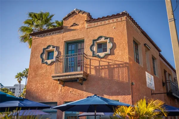 a front view of a building with sitting area