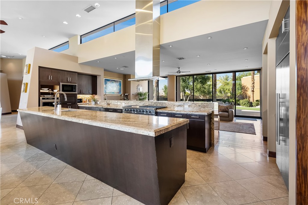 68 Royal St Georges Way Rancho Mirage, CA 92270 - Photo 28 of 75 a kitchen with kitchen island granite countertop a sink counter top space and stainless steel appliances