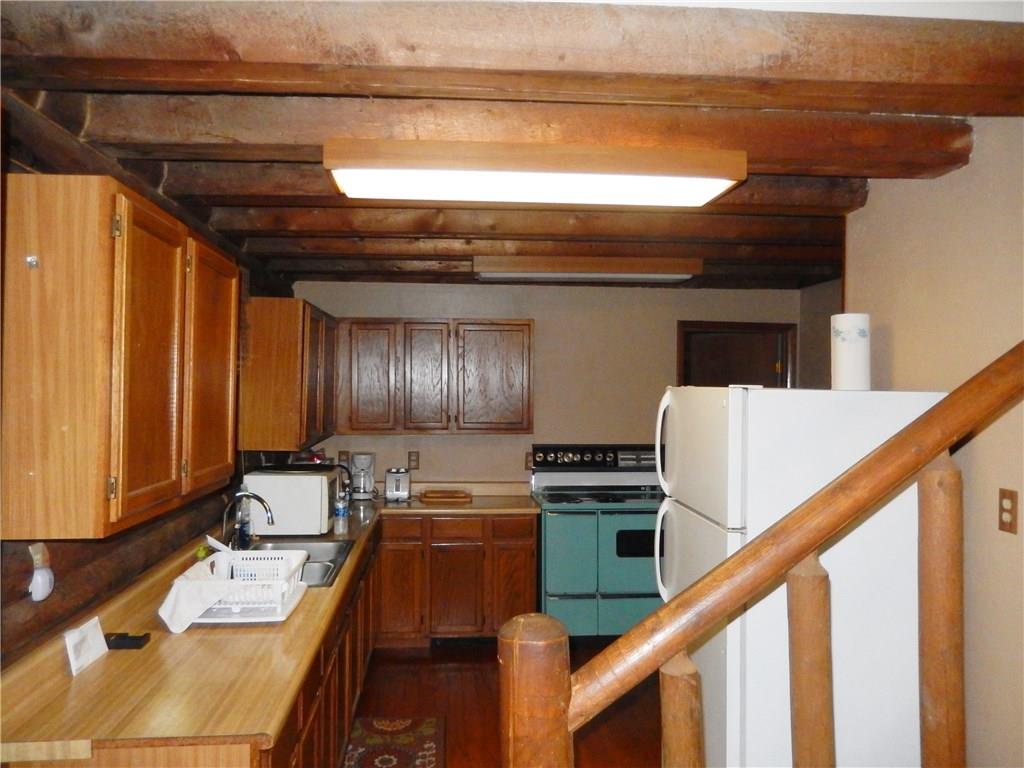 158 Sycamore Road Acme, PA 15610 - Photo 9 of 17 Kitchen includes electric stove and refrigerator