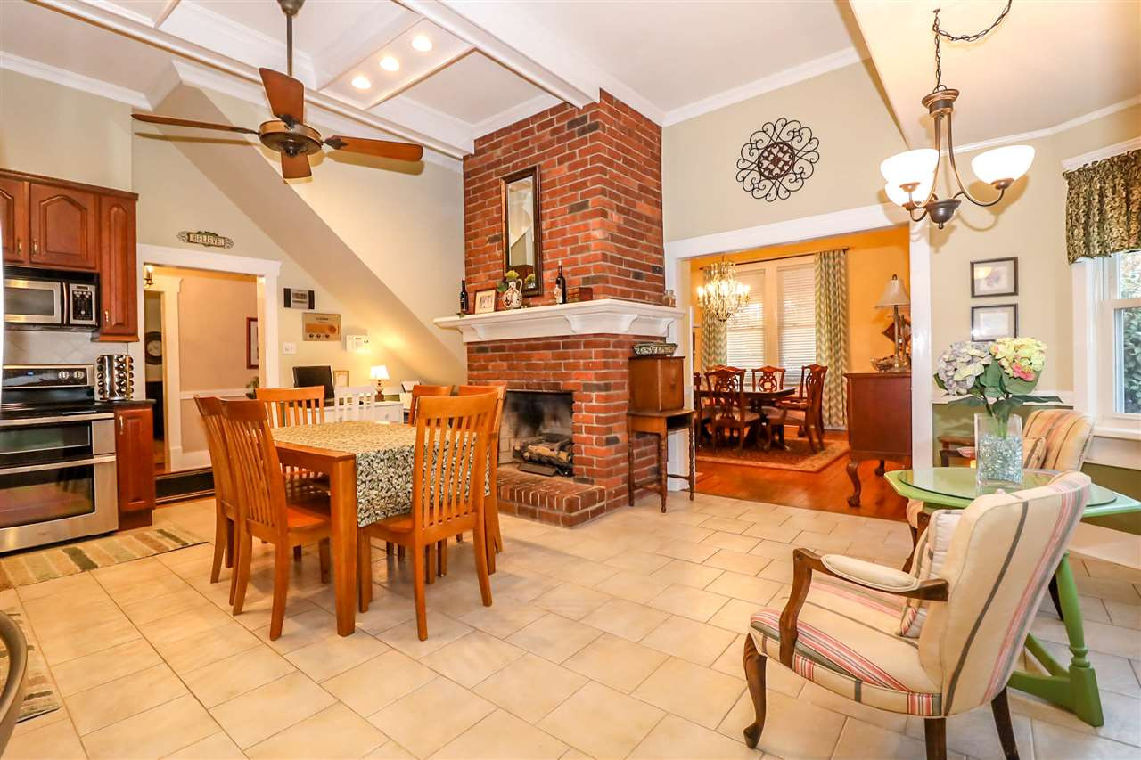 7745 Rock Quarry Road Raleigh, NC 27610 - Photo 6 of 25 Enjoy meals near the warmth of a functional propane gas fireplace right in the kitchen.