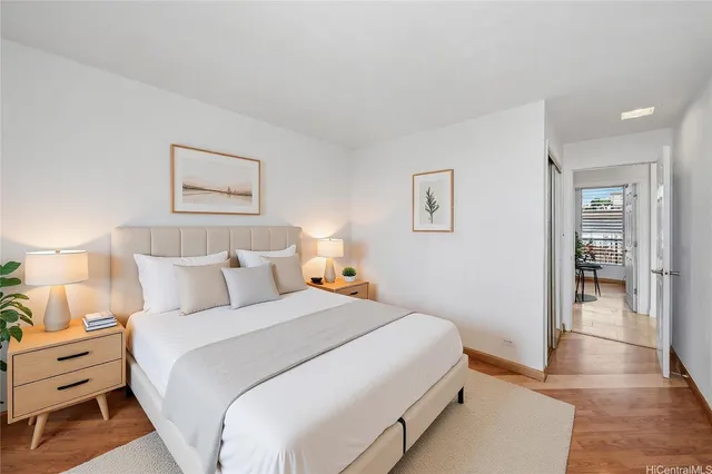 a bedroom with bed and a painting on the wall