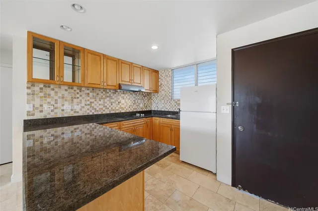 a view of kitchen with stainless steel appliances granite countertop cabinets and a refrigerator