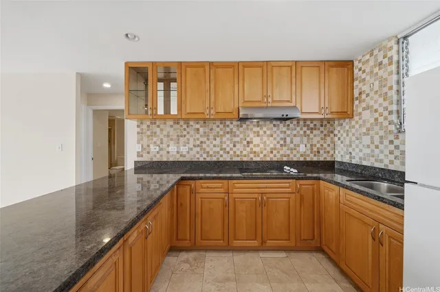 a kitchen with sink cabinets and window