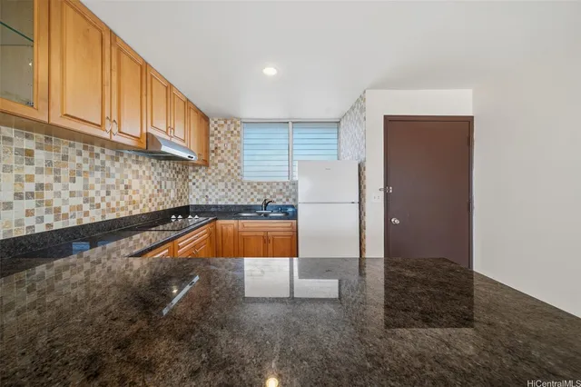 a view of a kitchen with kitchen island and a sink