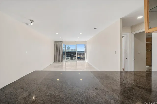 en empty room with windows and entrance