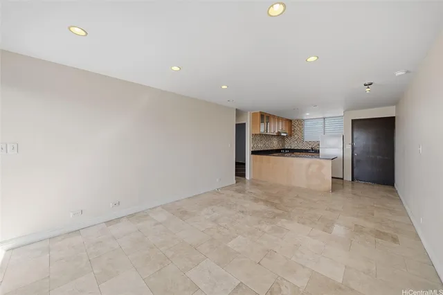 a view of a kitchen with a sink and a refrigerator