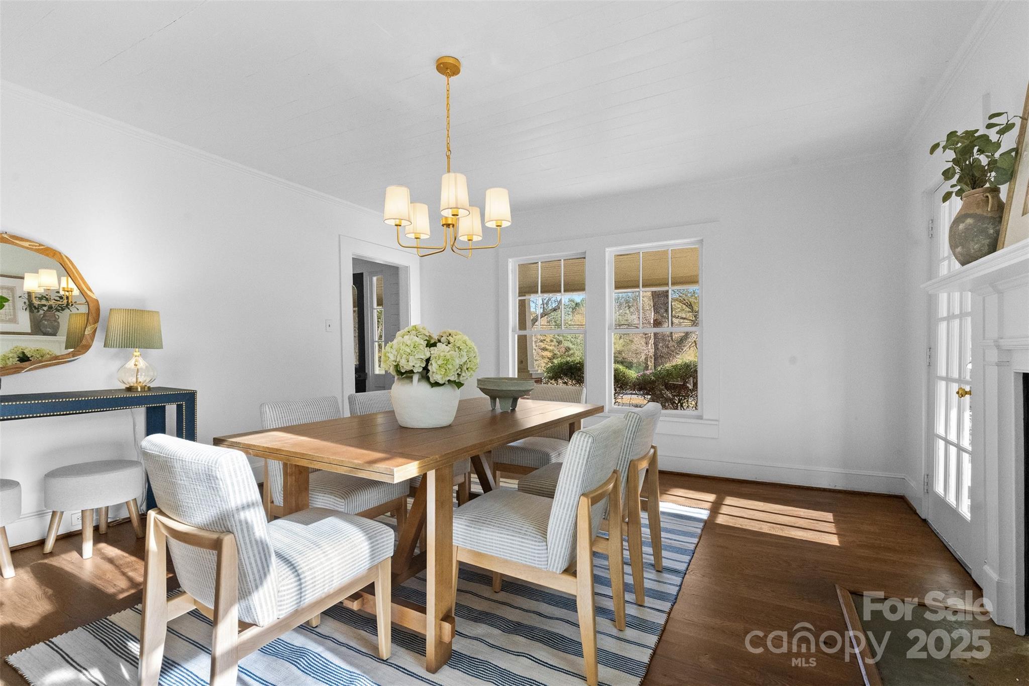 5607 Matthews-Mint Hill Road Charlotte, NC 28227 - Photo 14 of 45 a view of a dining room with furniture a chandelier and wooden floor