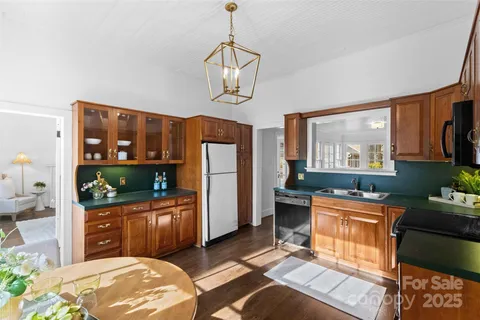 a kitchen with stainless steel appliances granite countertop a stove refrigerator and cabinets
