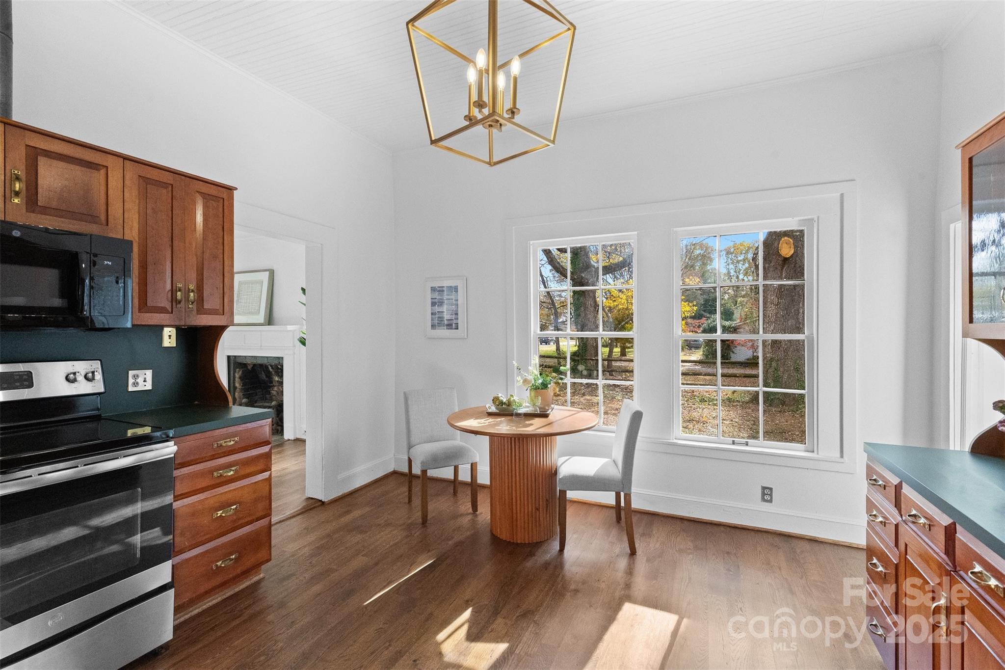 5607 Matthews-Mint Hill Road Charlotte, NC 28227 - Photo 17 of 45 a view of a dining room with furniture window and wooden floor