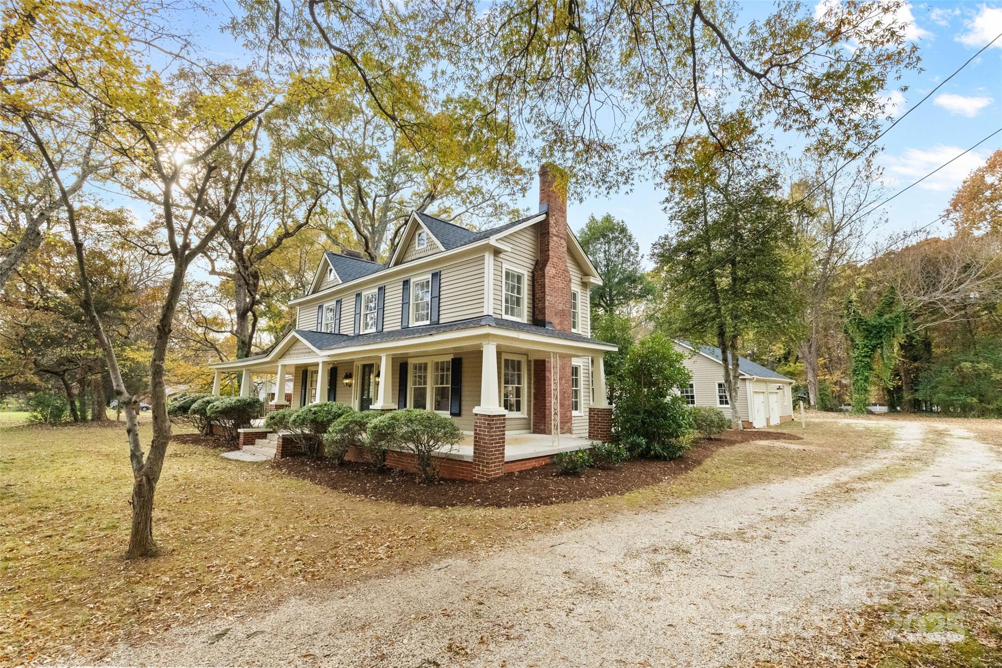 5607 Matthews-Mint Hill Road Charlotte, NC 28227 - Photo 2 of 45 a front view of a house with a yard and tree s